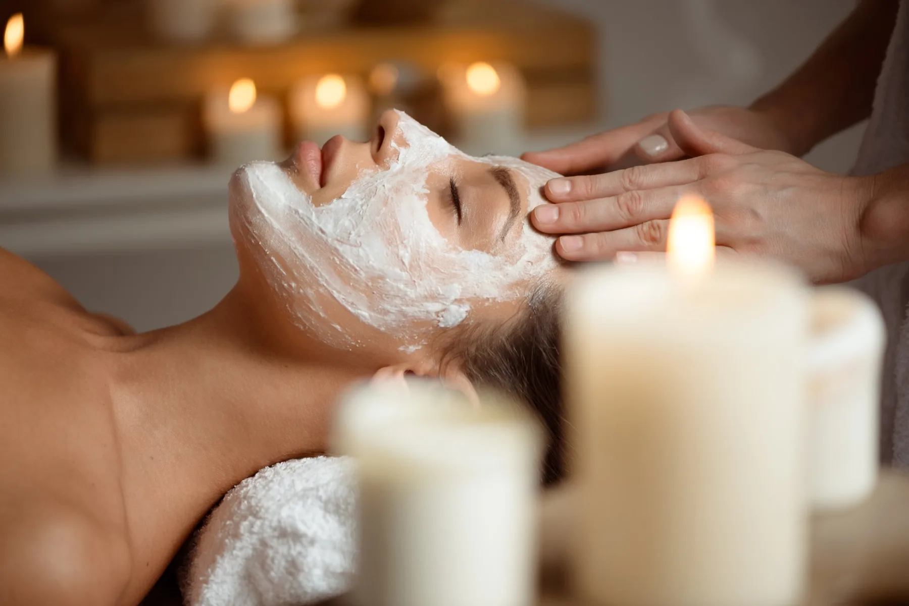 Trattamento viso con maschera e massaggio, luce di candele
